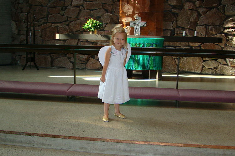 Enkelityttö Espoonlahden kirkon alttarin luona.