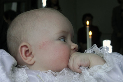 Baby is babtised with water.