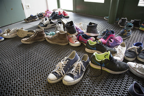 Many shoes in the hall.