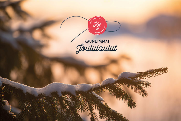 Kauneimmat joululaulut sinetinmuotoinen logo, taustalla luminen kuusen oksa.