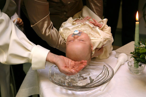 Baby is babtized with water.