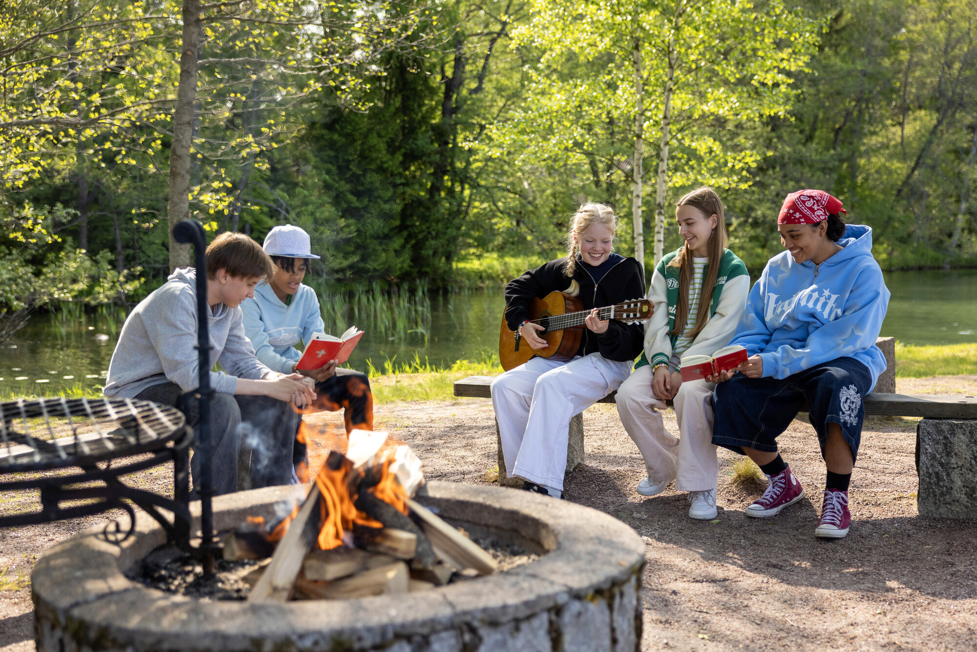 young people by a fire in ripari